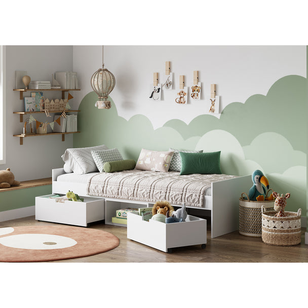 Children's bedroom with a bed, shelves, and toys against a cloud-themed wall.