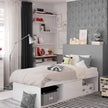White bed frame in a modernly decorated bedroom.