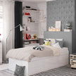 White bed frame in a modernly decorated bedroom.