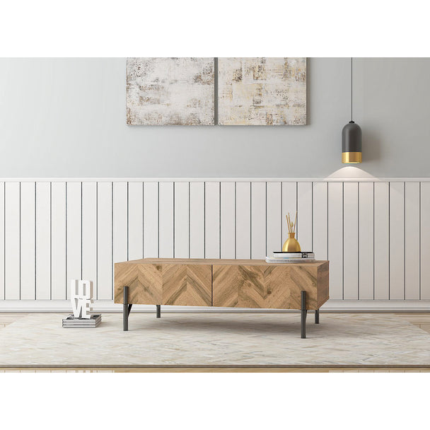 Coffee table in a modernly decorated living room. It shows 2 pull out drawers and the top surface area in use.